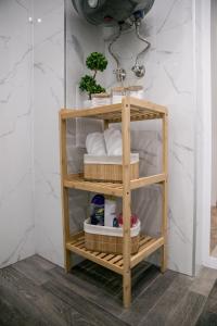 a wooden shelf with towels on it in a bathroom at VARNA SEA VIEW Apartment in Varna City +23 photos