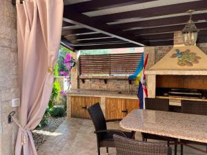 an outdoor kitchen with a table and a grill at Viola Istra Guest House in Štinjan