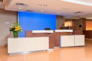 a lobby with a reception desk with a vase of flowers at Fairfield Inn & Suites by Marriott Orlando Kissimmee/Celebration in Orlando