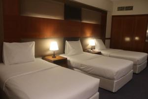 Voodi või voodid majutusasutuse GSS Avenue Hotel Ex Delmon Hotel toas