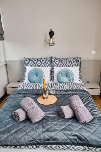 a bed with purple pillows and a table with a bottle and glasses at Babichy 29 DOM Apartamenty MANDORIA , Rodzina , Family , Orientarium , PTAK , Parking bezpłatny in Babichy