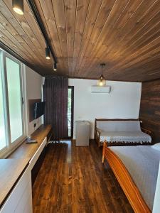 a bedroom with two beds and a wooden ceiling at SEA bed and restaurant 1 in Borsh