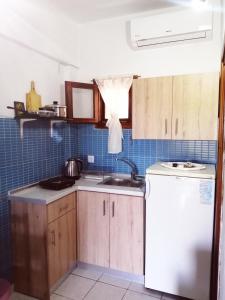 a kitchen with a sink and a refrigerator at Avra Ηouse in Kriopigi