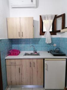 a kitchen counter with a sink and a window at Avra Ηouse in Kriopigi