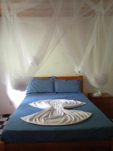 En eller flere senge i et værelse på Casa de Andréa