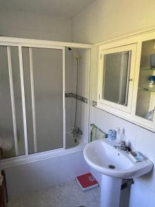 a bathroom with a white sink and a shower at La Fincurri del Nando in A Coruña +15 photos