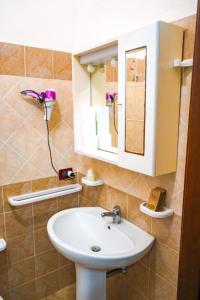 a bathroom with a sink and a mirror at MAESTRALE B&B in Arbus