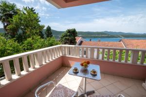 a balcony with a table with fruit on it at Villa Nikola in Neum