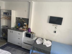 a small room with a bed and a microwave at Amida Family pansiyon in Istanbul