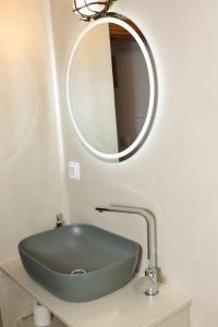 a bathroom with a green sink and a mirror at Titinas' in Plomari +33 photos