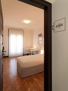 a bedroom with a bed and a table at Uporto House Villa in Porto