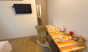a room with a table and chairs and a television at Casa Vilma in Paderno del Grappa +4 photos