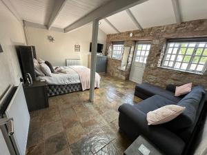 a bedroom with a couch and a bed in a room at Dwylig Isa Holiday Cottages in Rhuddlan +63 photos