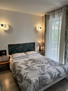 a bedroom with a bed and a large window at Chalet Mavalear naturiste La Jenny in Le Porge