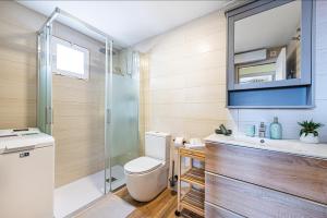 a bathroom with a toilet and a sink and a shower at Apartamento Costa African in La Mata +44 photos