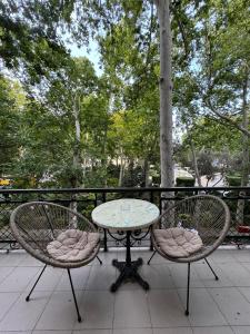 two chairs and a table on a patio at Zimmer Boutique Hotel in Baku