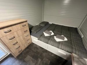 a small room with two beds and a dresser at Mobile house T&N in Velenje