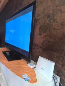 a computer monitor and a laptop sitting on a desk at Ka la paca in Grao de Castellón +61 photos