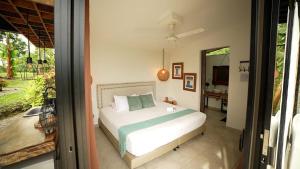 a bedroom with a bed and a mirror at Botánikal Hotel in Montenegro