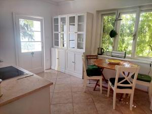a kitchen with a table and a table and chairs at Villa Margaretha in Badacsonytomaj