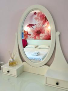 a bedroom with a bed with a round mirror at Studios Ioulia in Keramot&iacute;