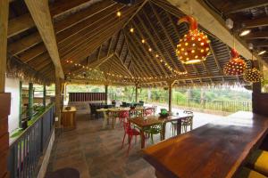 a large pavilion with tables and chairs and a chandelier at La Semilla Ecolodge in Cerro Azul