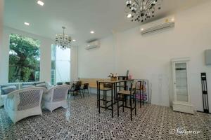 a living room with a table and chairs at Bananaleaf Wedding Cafe & Resort in Ban Bang Kaeo