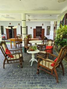 a patio with chairs and a table and a table and chairs at Madoldu Eco Resort in Ahangama