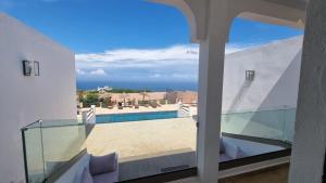a view of the pool from the balcony of a house at Villa avec piscine Asilah, terrain de foot privative in Asilah