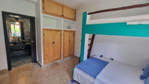 a bedroom with a bunk bed and a bathroom at Villa avec piscine Asilah, terrain de foot privative in Asilah