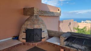 a building with a fireplace on a balcony at Villa avec piscine Asilah, terrain de foot privative in Asilah