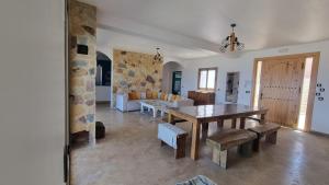 a living room with a table and a couch at Villa avec piscine Asilah, terrain de foot privative in Asilah