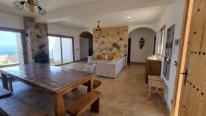 a living room with a table and a couch at Villa avec piscine Asilah, terrain de foot privative in Asilah
