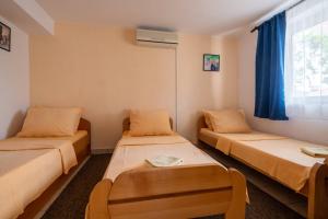 a room with two beds and a window at Villa Nikola in Neum
