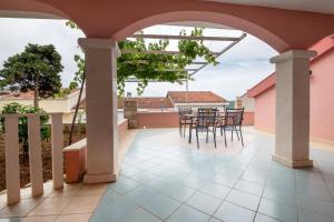a patio with a table and chairs on it at Villa Nikola in Neum