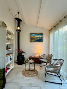 a living room with two chairs and a table at Evasion de rêve à Casa Nina in Borgo