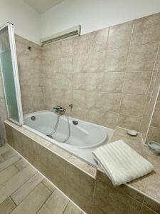 a bathroom with a bath tub in a room at Evasion de rêve à Casa Nina in Borgo +39 photos