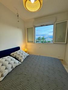 a bedroom with a large bed and a window at Evasion de rêve à Casa Nina in Borgo