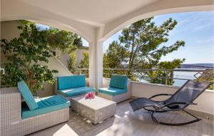 a patio with two chairs and a table and a chair at Gorgeous Home In Cesarica in Cesarica