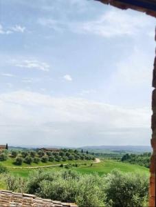 a view from a window of a golf course at PodereVicoBasso Siena in Siena