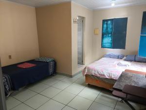 Una cama o camas en una habitación de Quartos Econômicos