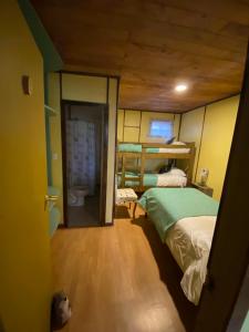 a bedroom with a bunk bed and a bathroom at Departamento La Solar in Frutillar