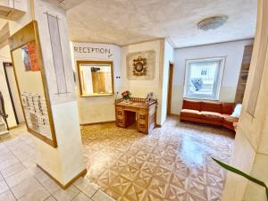 a living room with a table and a couch at Appartamenti Villa Flora by AMA Val di Fassa in Canazei