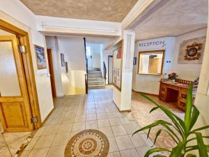 a hallway of a hotel with a staircase and a hallway at Appartamenti Villa Flora by AMA Val di Fassa in Canazei