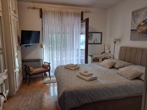 a bedroom with a bed with two towels on it at Apartment Summer in Šibenik