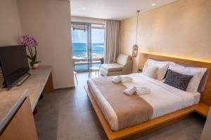 a hotel room with a bed and a television at Da Luz Boutique Hotel in Sarandë
