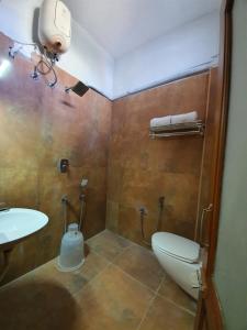 a bathroom with a toilet and a sink at Le Supreme Inn (the lap of luxury) in Puducherry