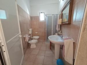 a bathroom with a toilet and a sink at Casa Colonica Liliane B&B in Porto Cesareo