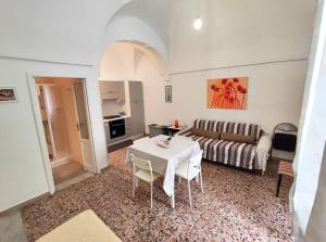 a living room with a table and a couch at Home Pugliese in Ceglie Messapica +14 photos