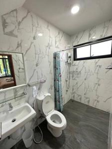 a bathroom with a toilet and a sink at Mountain hills house poolvilla saraburi muaklek in Ban Sap Phrik